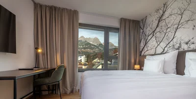 Junior Suite mit Baumzweig-Tapete, Schreibtisch und herrlichem Steinberge-Panorama