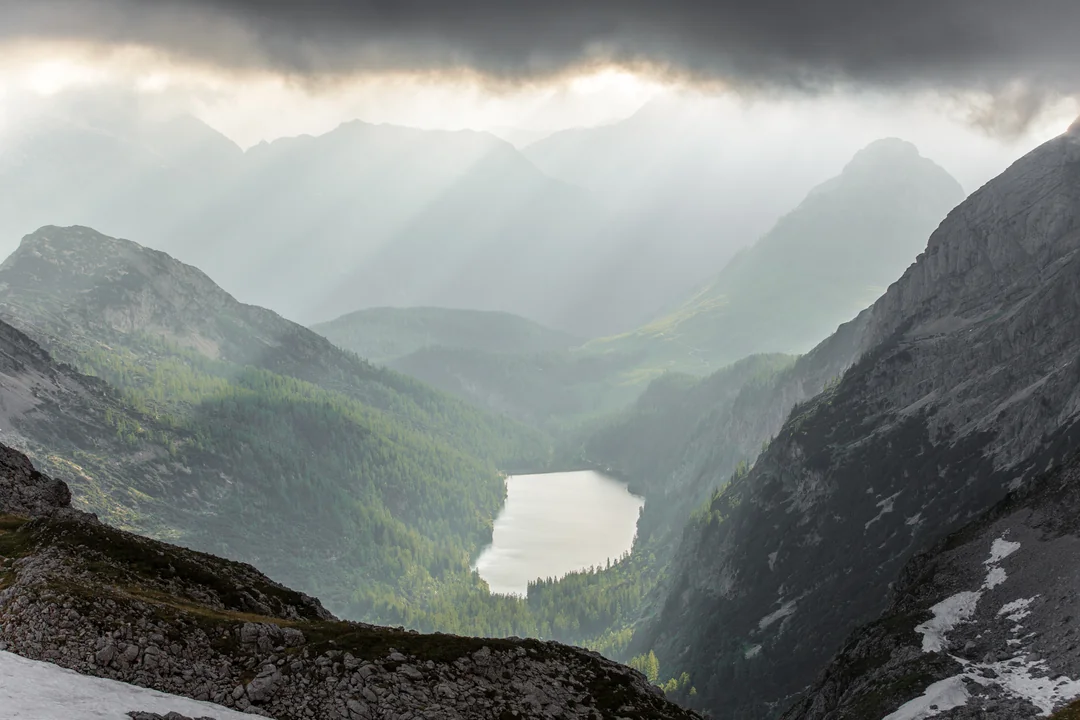 Mountain lake with sun rays in the high mountains – placeholder image